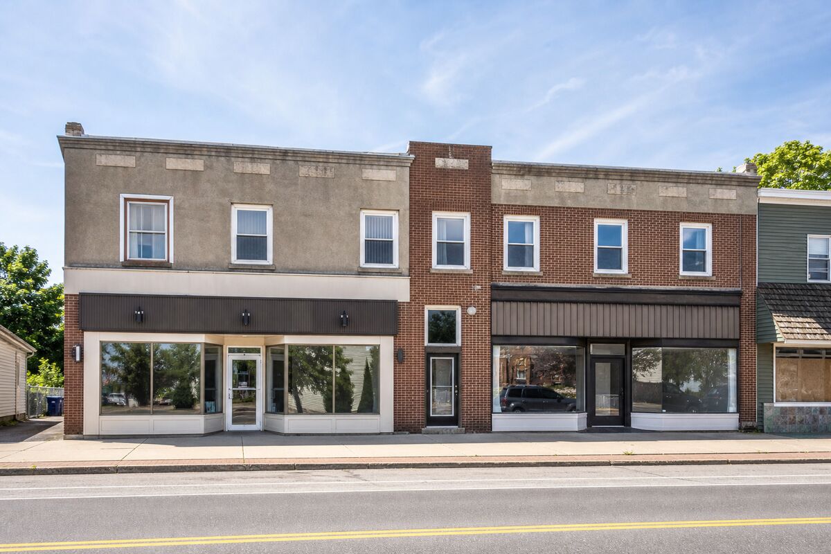 Exterior of a two-story main-street mixed-use building with ground-floor retail